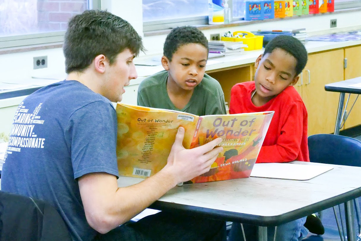 Tutor works with student