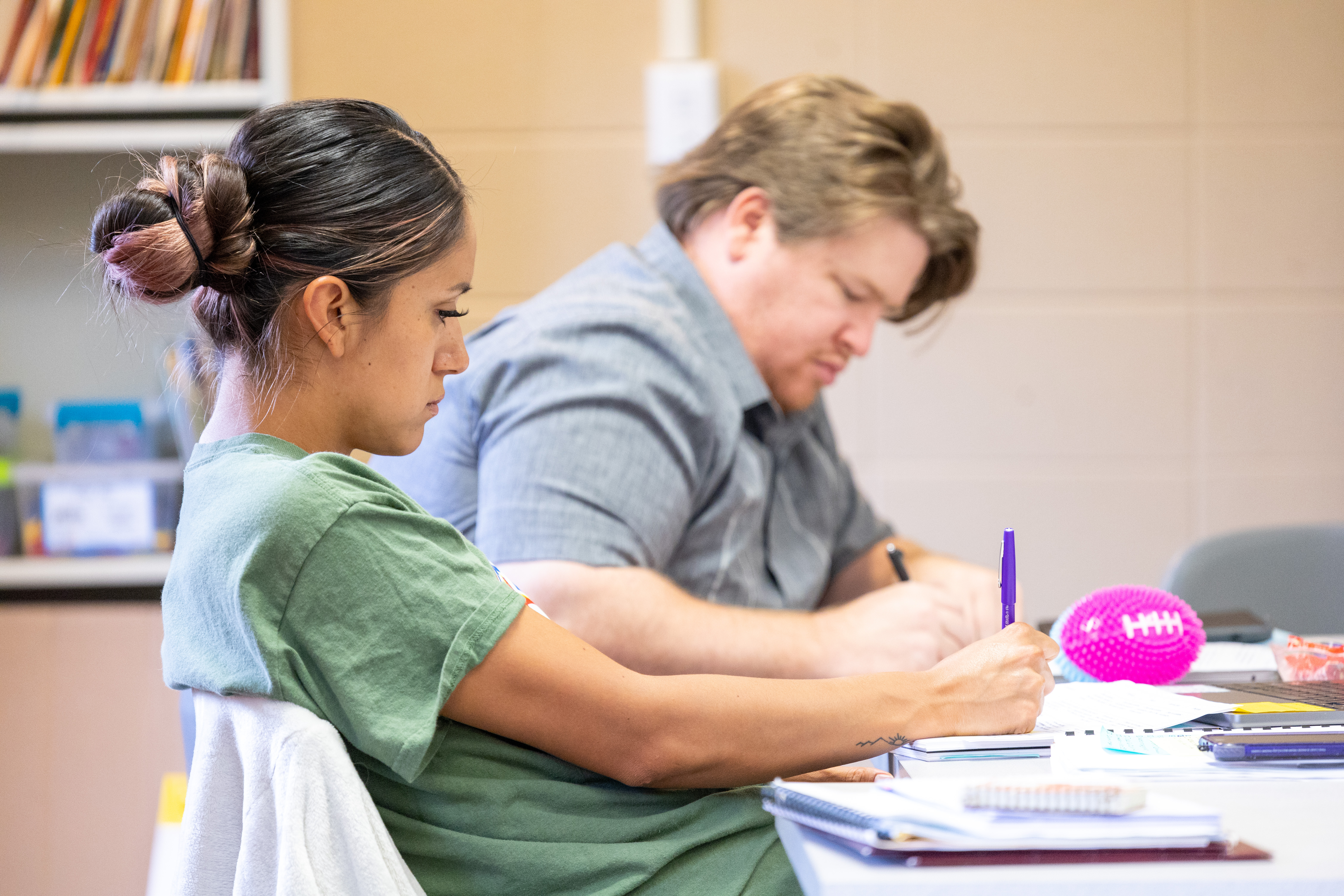 AICSN Holy Cross Fellow writing in class