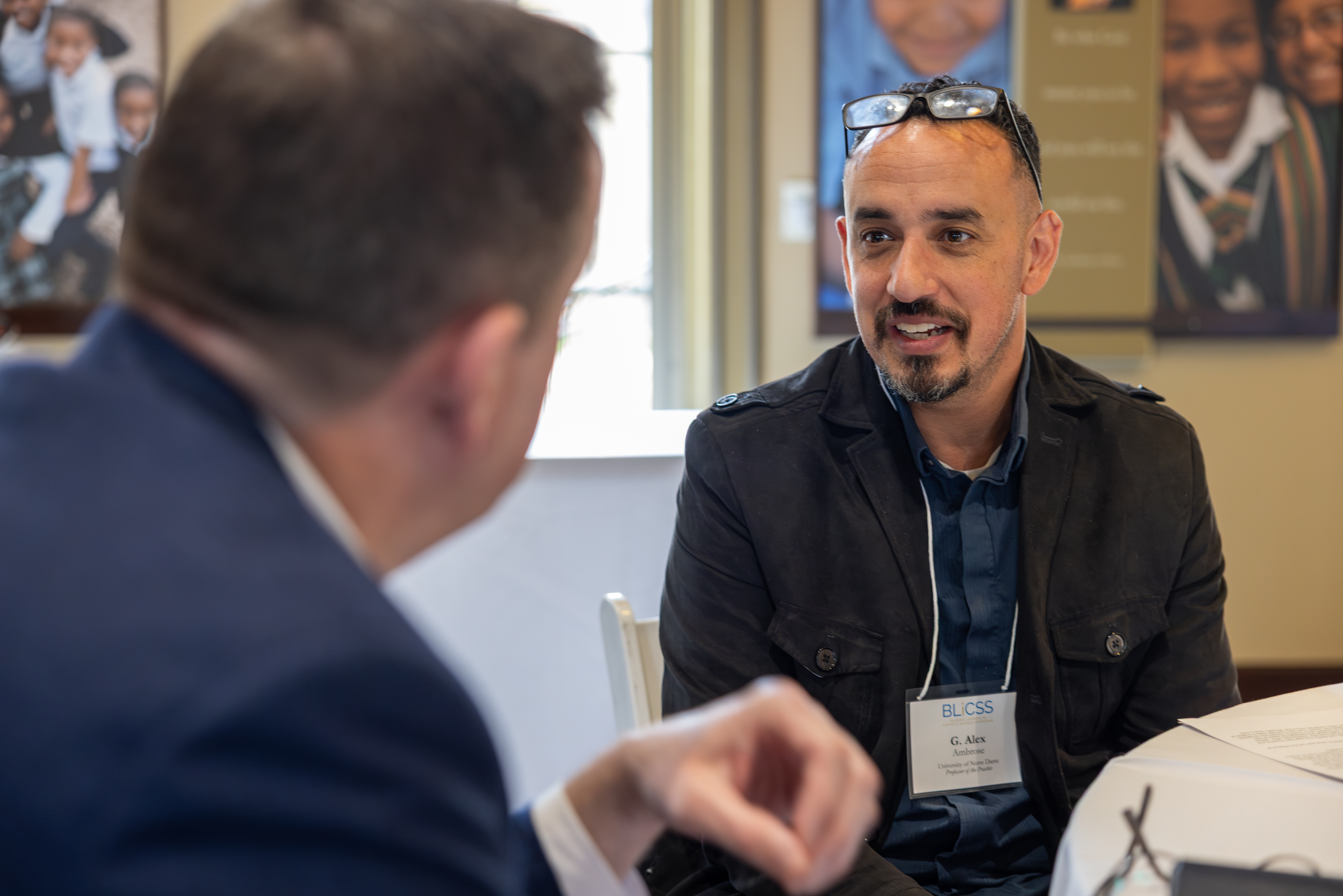 Lewis Poche discussing at table