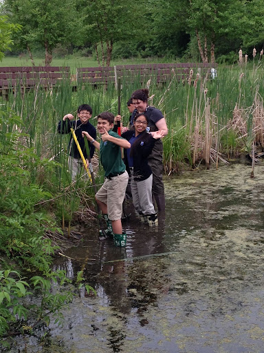 Miss Giroux and students working in the Corpus Christi Outdoor Learning Pond