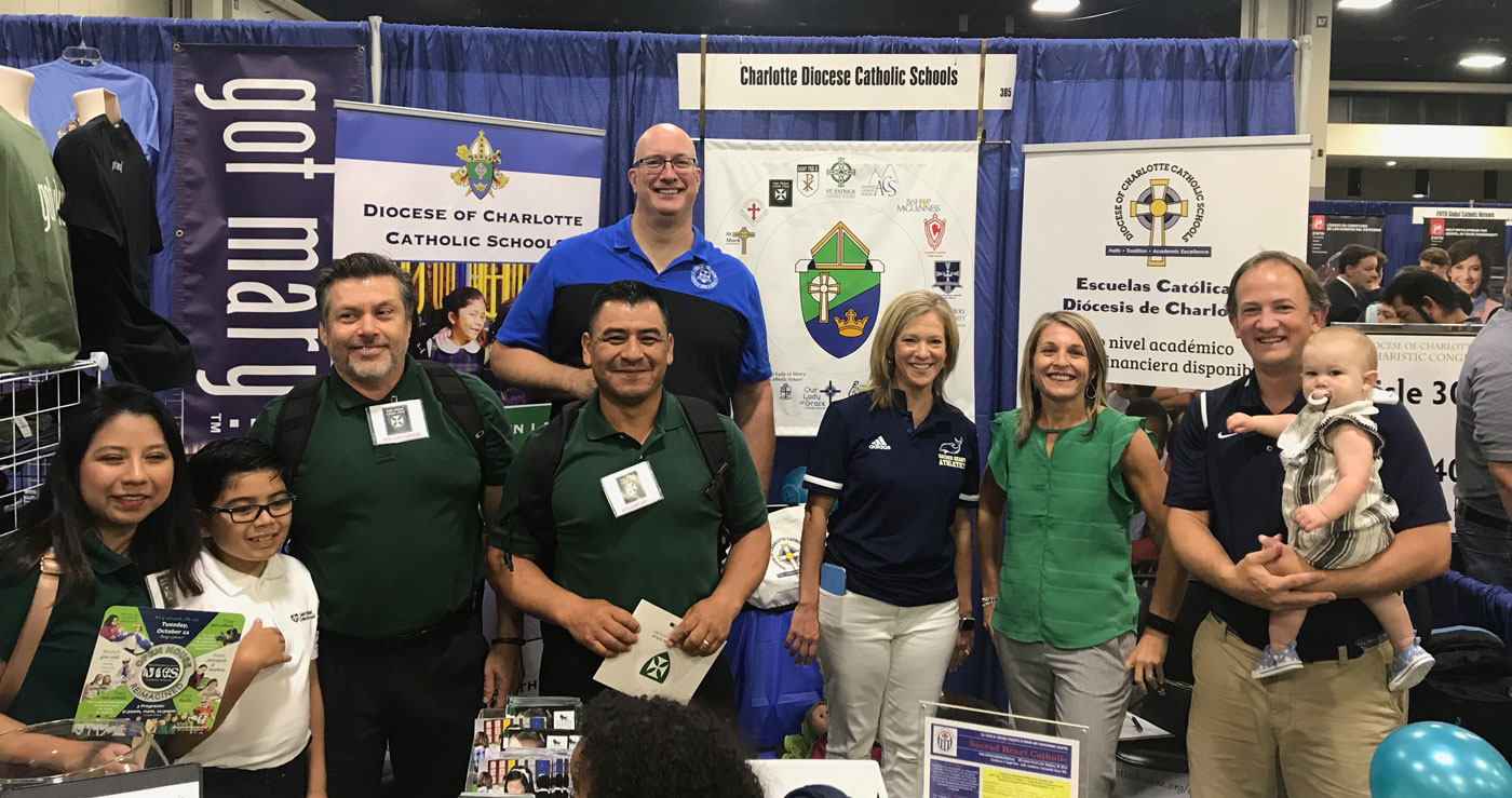 Angelica Hurtado and some of their madrinas/padrinos promoting Diocese of Charlotte Catholic schools.