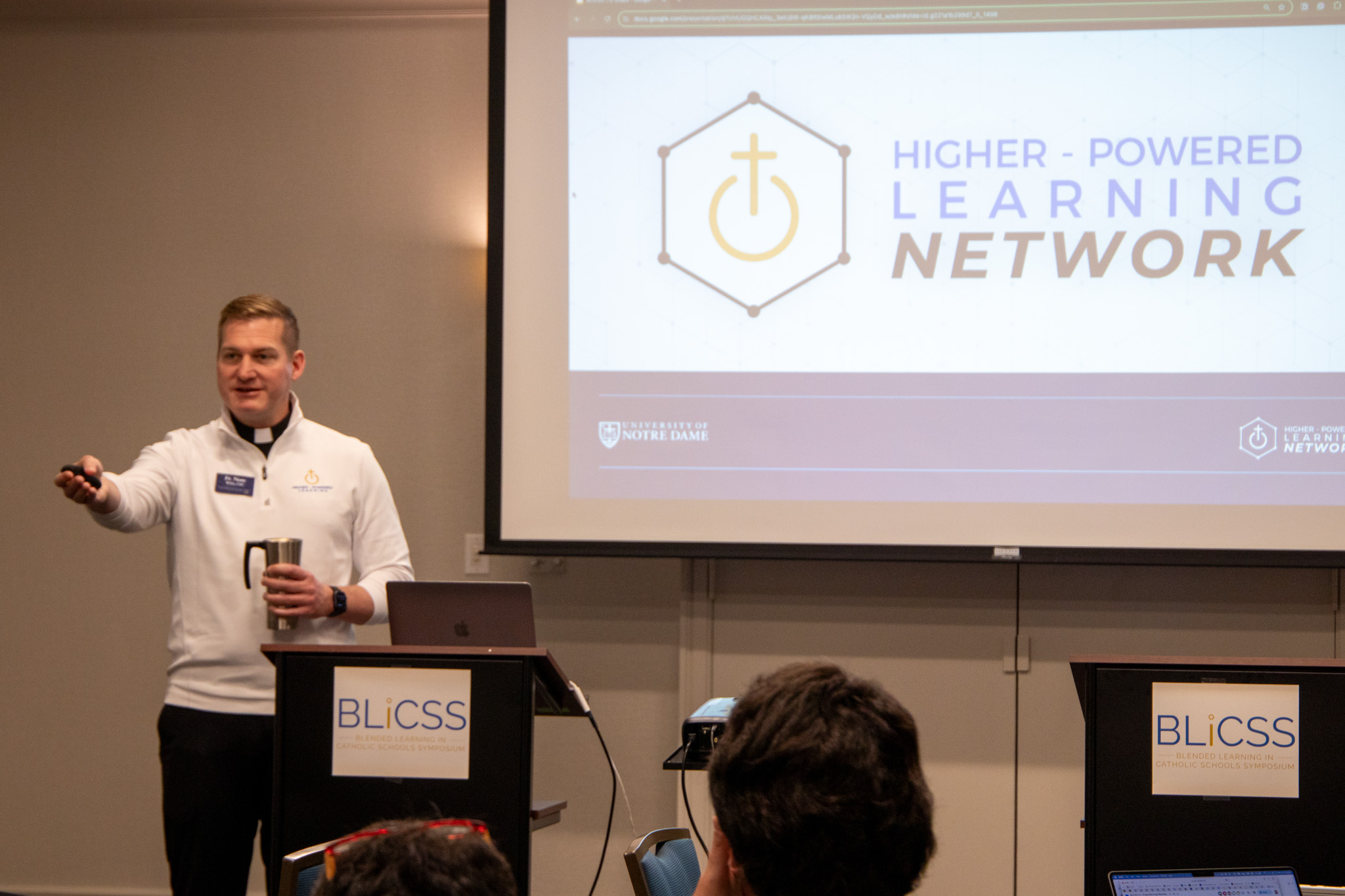Image of Fr. Nate Wills pointing a someone off screen during his presentation at BLiCSS 7.0