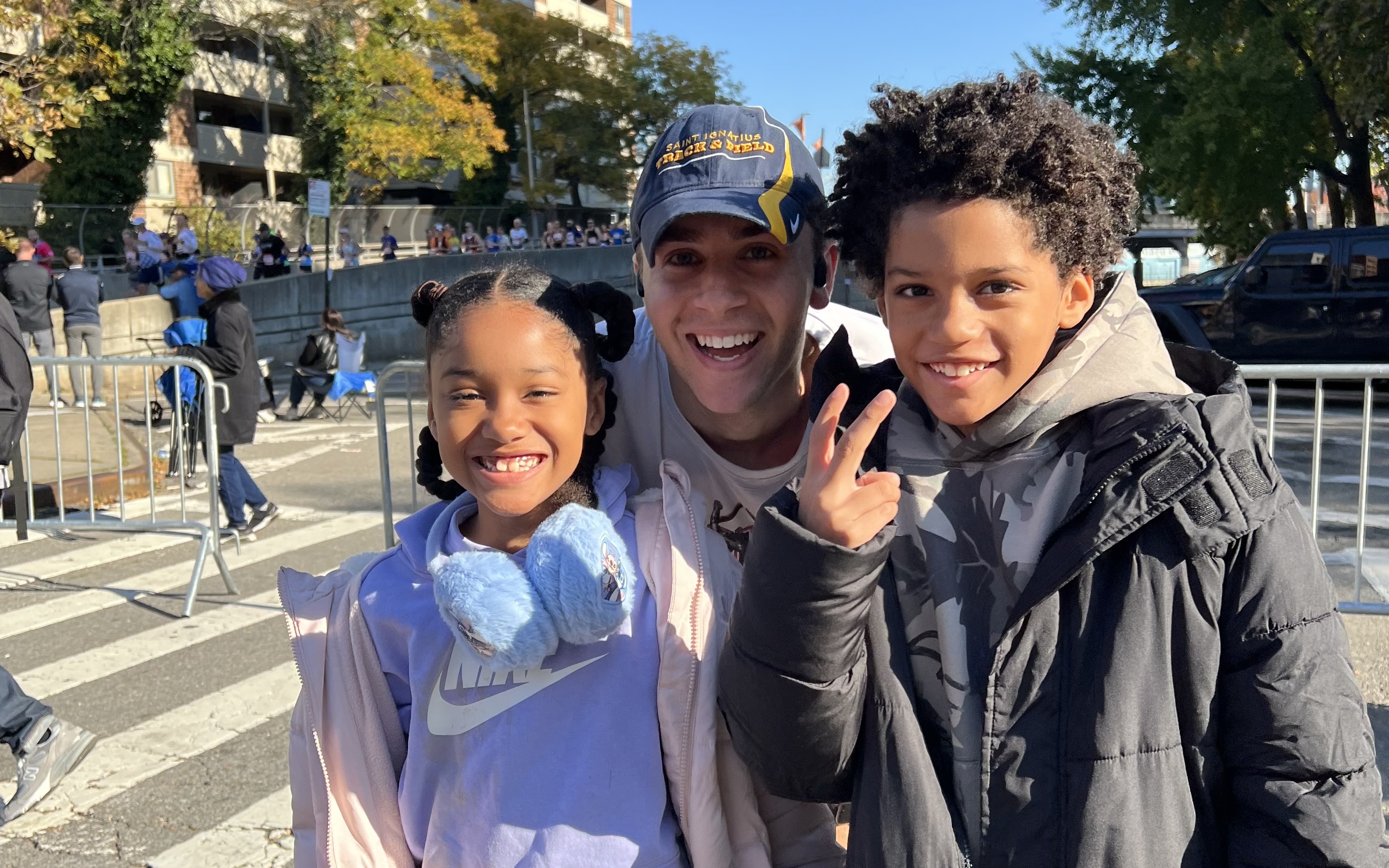 Jack Hutter (middle) with two of his students (left and right) posing for a photo at the NYC Marathon 2025