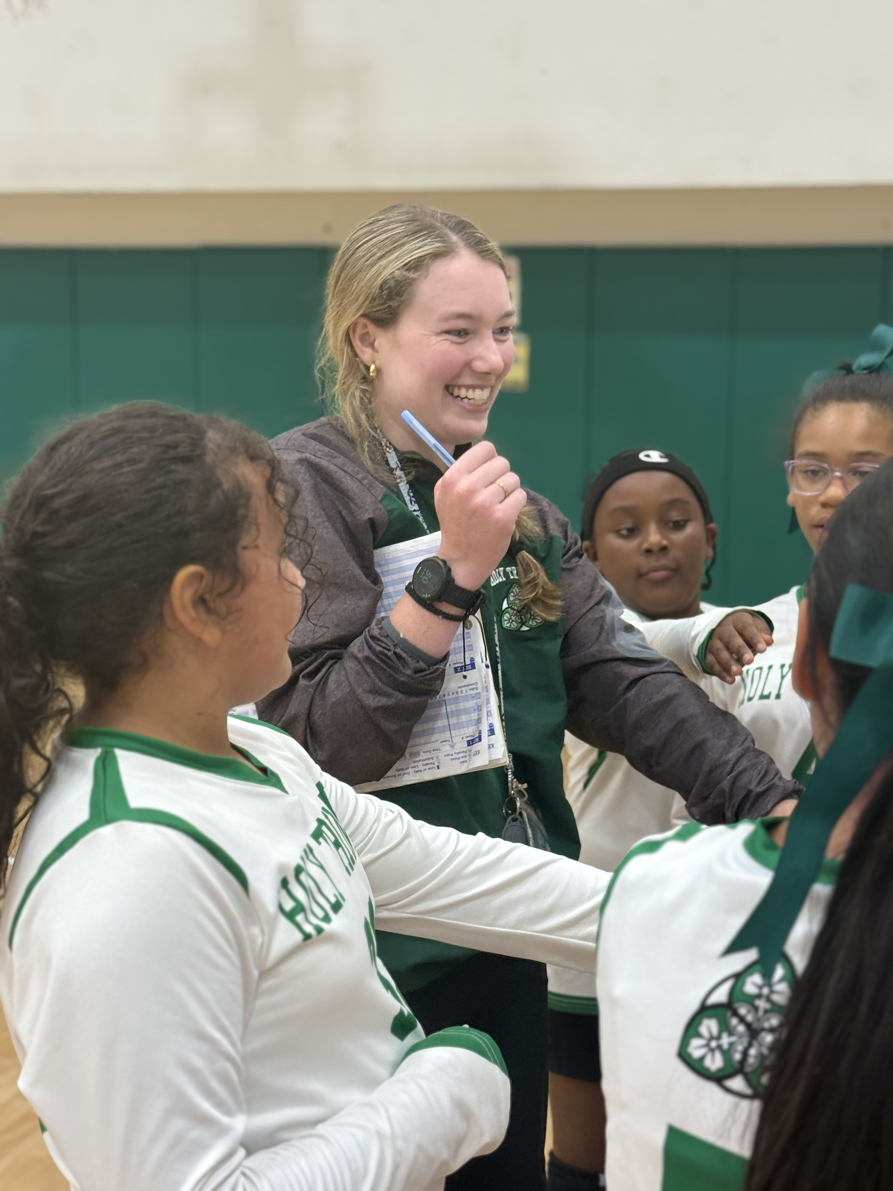 Mary Margaret Schroeder helping coach students are her school
