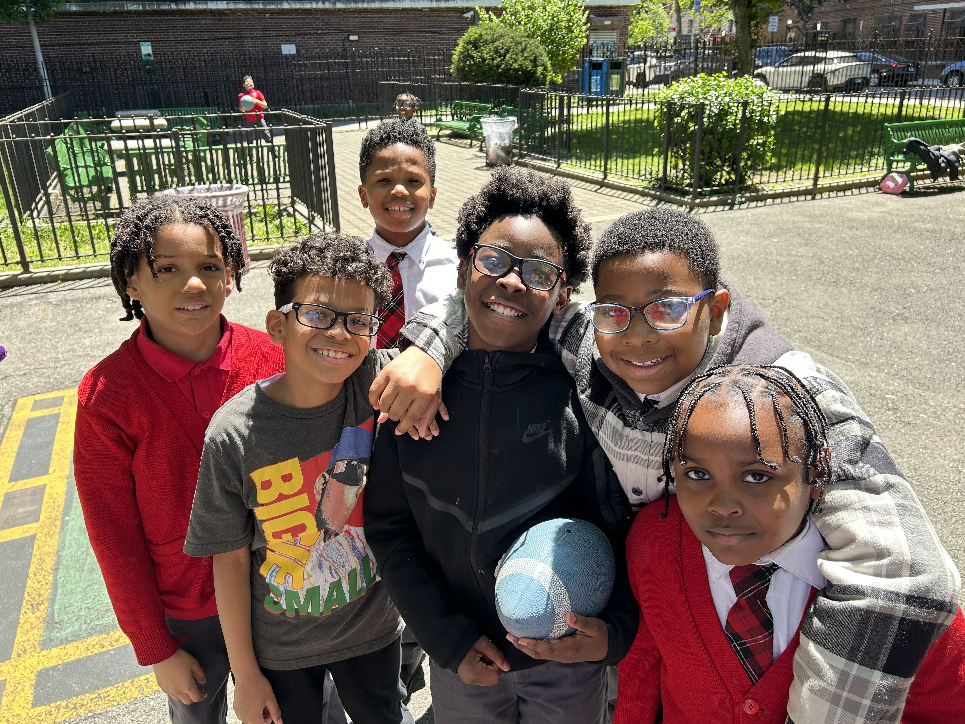 Picture of Jack Hutter's students outside in various red school uniforms