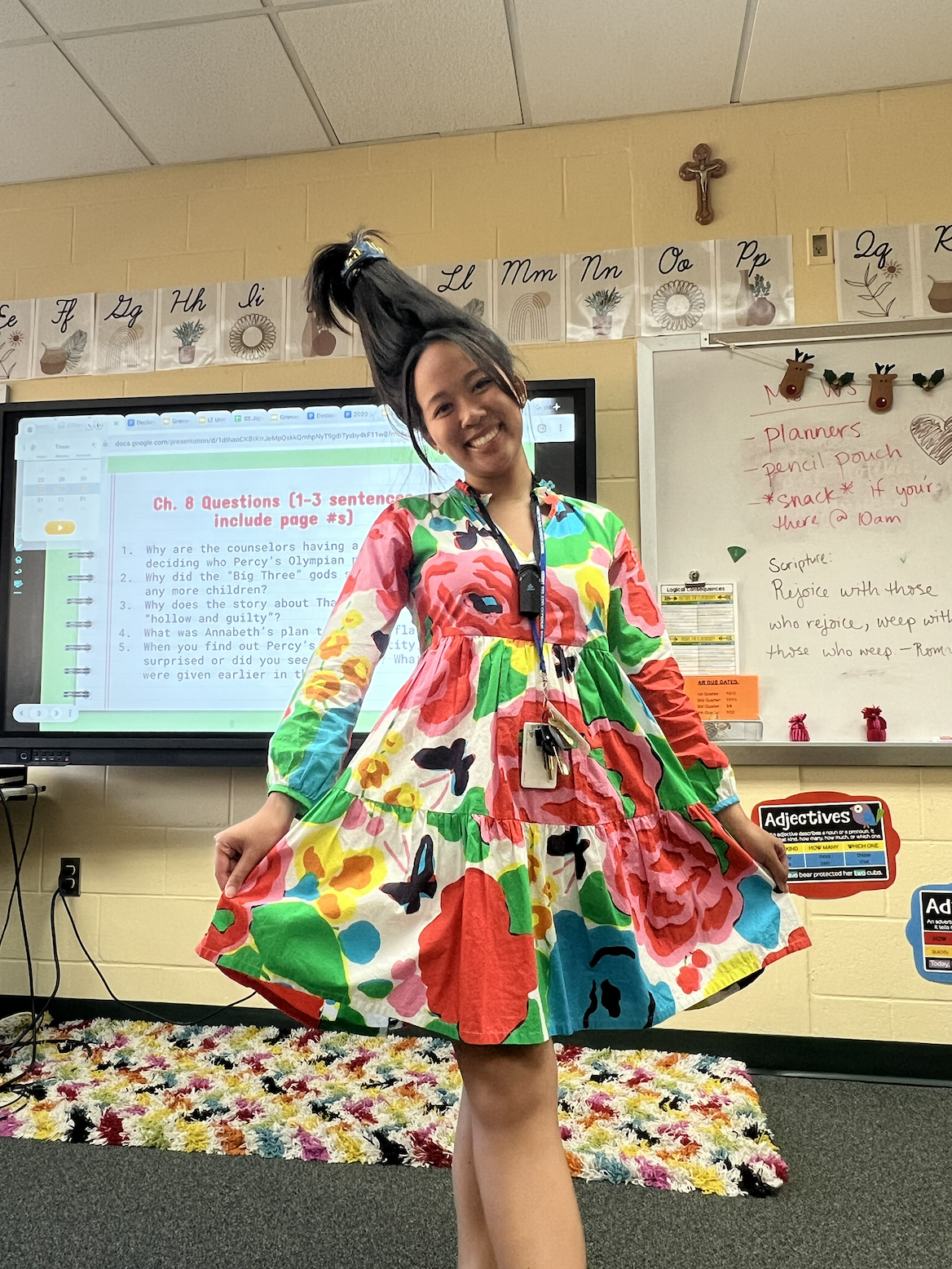 Uyen Le dressed up for Catholic Schools Week with a color dress and crazy hair