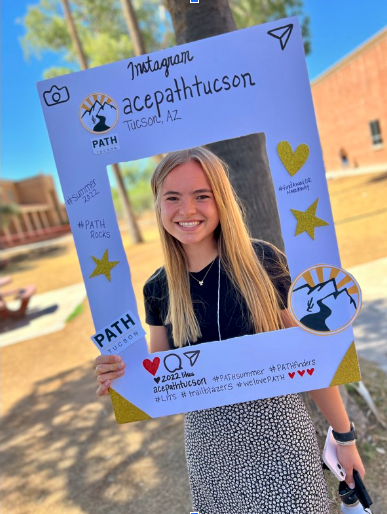 Image of Rachel Thompson with a PATH sign