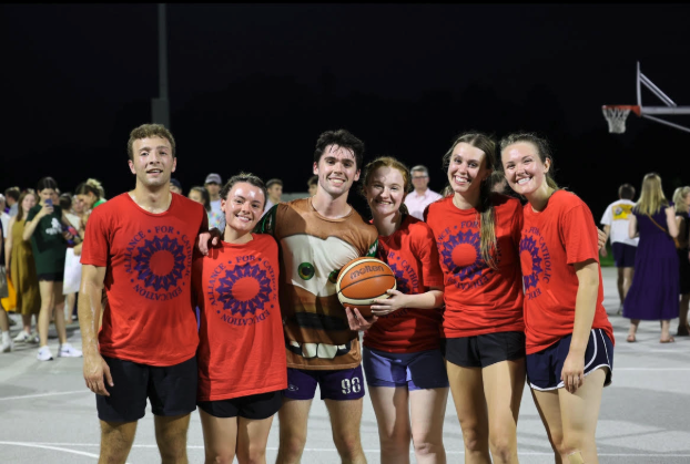 ACE Cleveland in red ACE t-shirts (with Glasgow in a Tow Mater t-shirt) posing for the camera after a basketball game. From left to right: Marcello Nanni, Cat Darcy, Clayton Glasgow, Kristen O'Sullivan, Grace Shean, and Ashley Utnage)