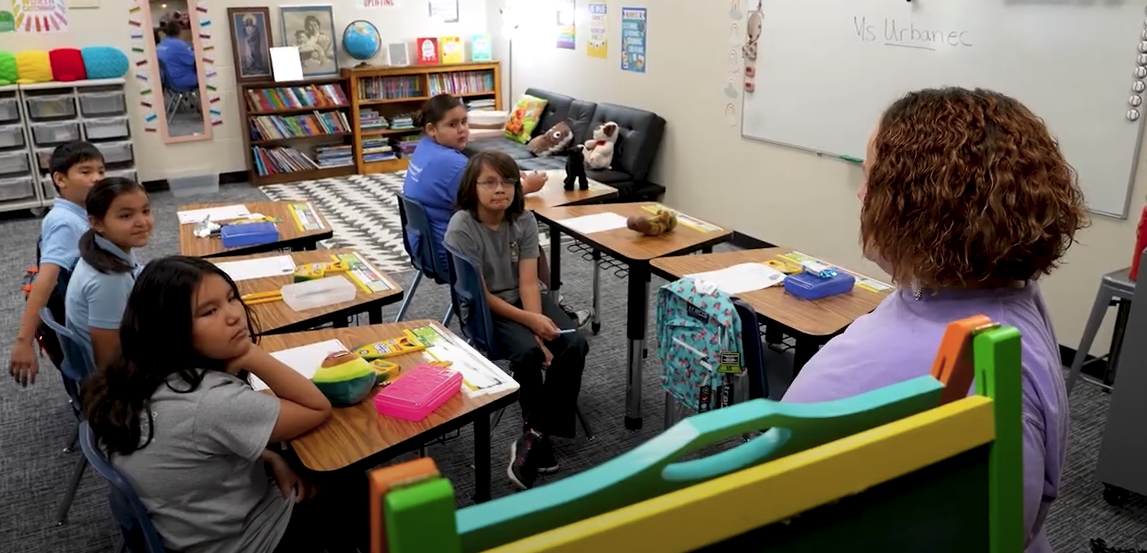 Teachers speaking to students in classroom