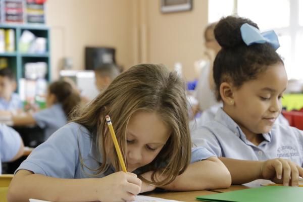 Students writing at desk