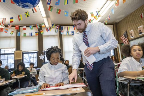 Teacher (right) point to students work (left)