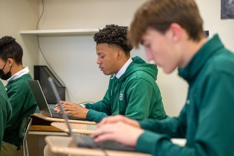 Students typing on laptops
