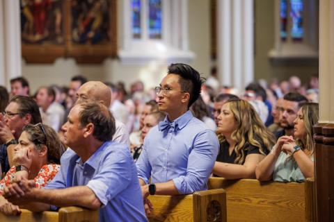 ACE graduate kneeling in prayer