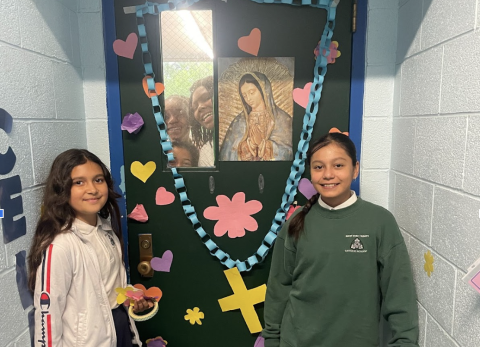 Students in front of class door smiling