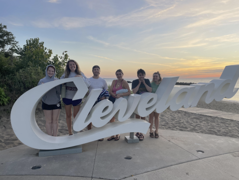 From left to right: Kristen, Ashley, Marcello, Grace, Clayton, and Catherine in front of the Cleveland sign at Lake Eerie