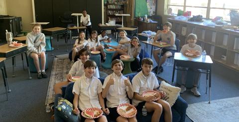 Ms. Hall's sixth grade home room posing for a photo from their Christmas party.