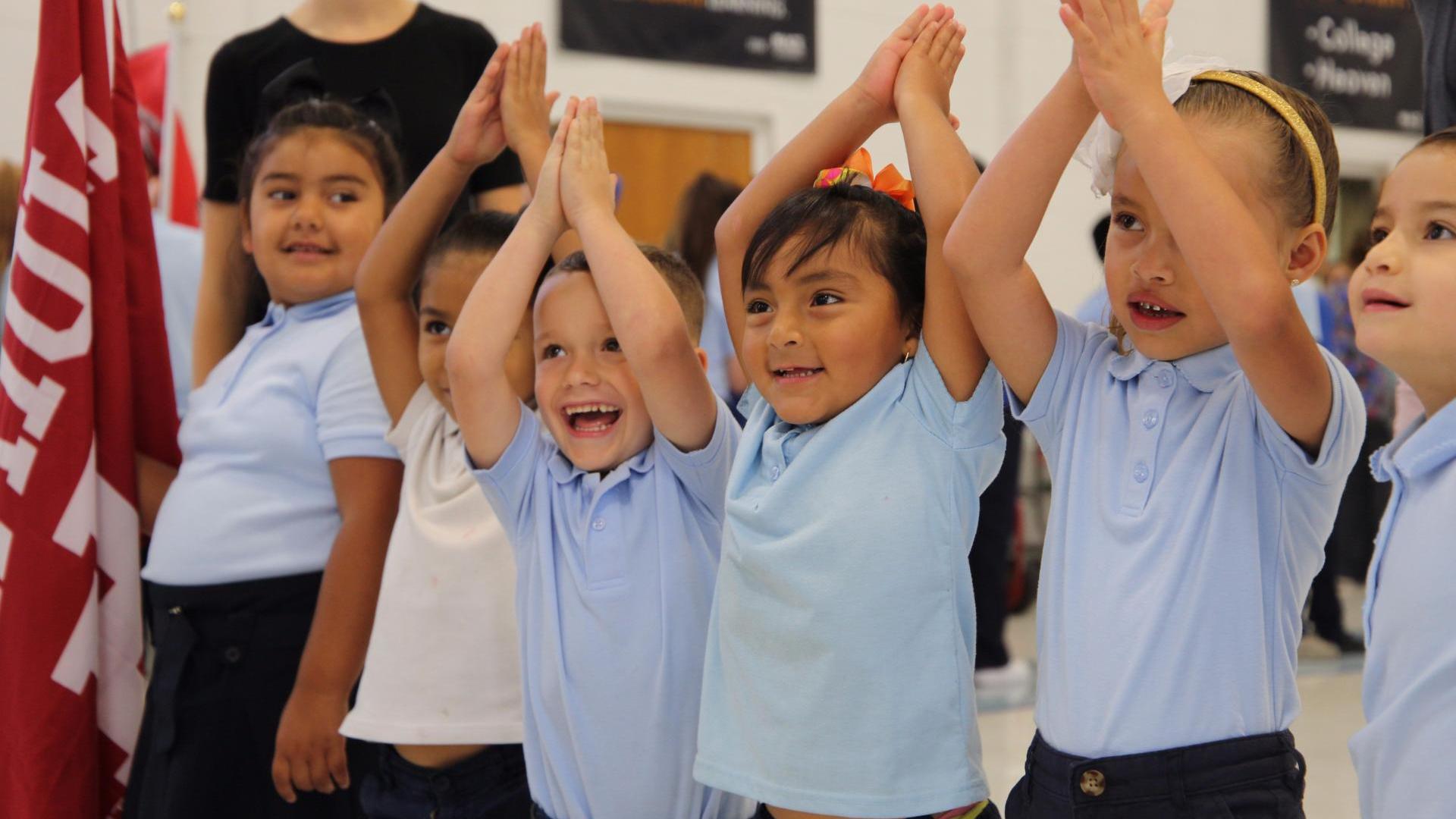 Kids cheering in school